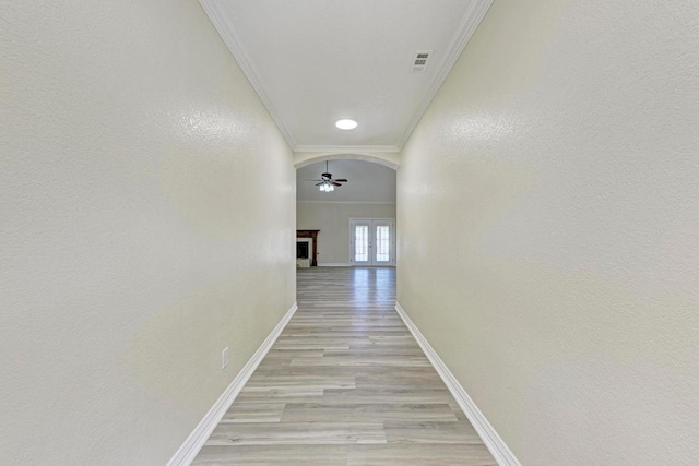 903 N Neans Dr, Austin, TX 78758 - hall with ornamental molding, light wood finished floors, and arched walkways