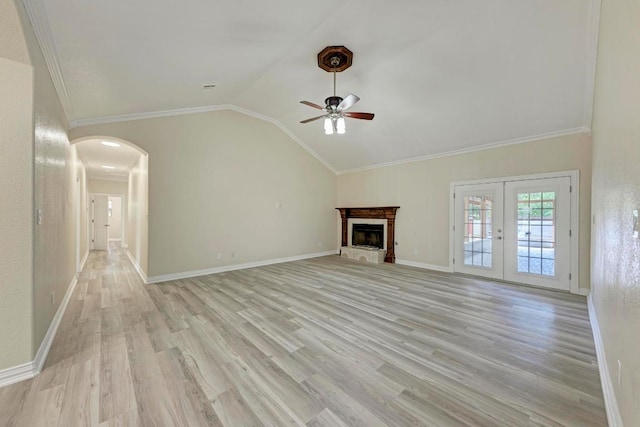 903 N Neans Dr, Austin, TX 78758 - unfurnished living room with a ceiling fan, light wood-type flooring, vaulted ceiling, arched walkways, and crown molding