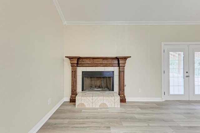 903 N Neans Dr, Austin, TX 78758 - unfurnished living room with ornamental molding, a tiled fireplace, french doors, and wood finished floors