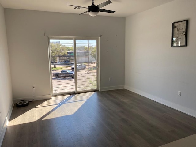 2220 Webberville Rd Unit 204, Austin, TX 78702 - unfurnished room featuring dark wood finished floors, ceiling fan, and baseboards