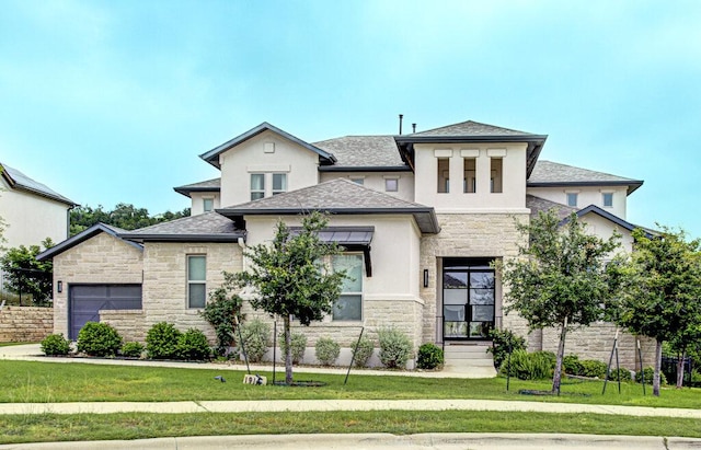1916 Port Bari Ct, Leander, TX 78641 - view of front of home with stone siding, stucco siding, a front lawn, and a garage