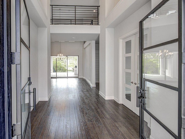 1916 Port Bari Ct, Leander, TX 78641 - entrance foyer with a chandelier, baseboards, dark wood-style flooring, french doors, and a towering ceiling