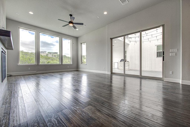 1916 Port Bari Ct, Leander, TX 78641 - unfurnished living room with ceiling fan, wood finished floors, recessed lighting, and baseboards