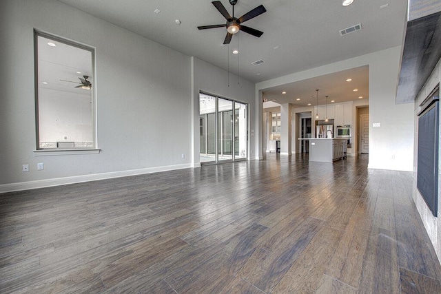 1916 Port Bari Ct, Leander, TX 78641 - unfurnished living room with a ceiling fan, dark wood-type flooring, recessed lighting, baseboards, and a sink