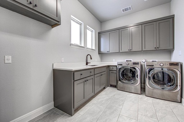 1916 Port Bari Ct, Leander, TX 78641 - laundry area featuring cabinet space, washing machine and clothes dryer, and baseboards