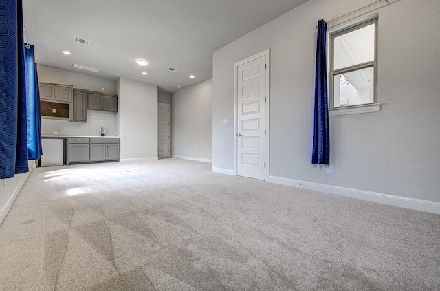 1916 Port Bari Ct, Leander, TX 78641 - unfurnished living room featuring baseboards, carpet floors, recessed lighting, and a sink
