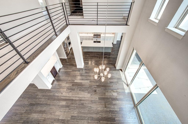 1916 Port Bari Ct, Leander, TX 78641 - unfurnished living room featuring a chandelier and wood finished floors