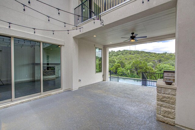 1916 Port Bari Ct, Leander, TX 78641 - view of patio with a balcony, ceiling fan, a forest view, and an outdoor pool