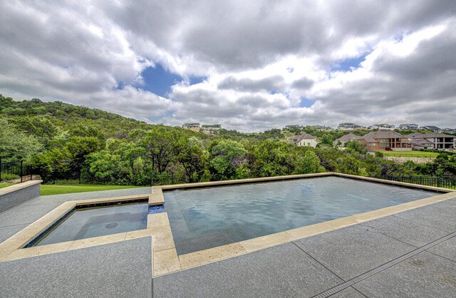 1916 Port Bari Ct, Leander, TX 78641 - outdoor pool featuring a forest view