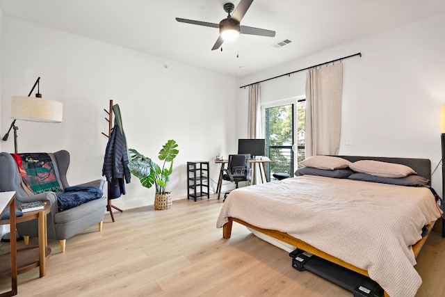 3101 Govalle Ave Unit 219, Austin, TX 78702 - bedroom with light wood finished floors, a desk, and ceiling fan