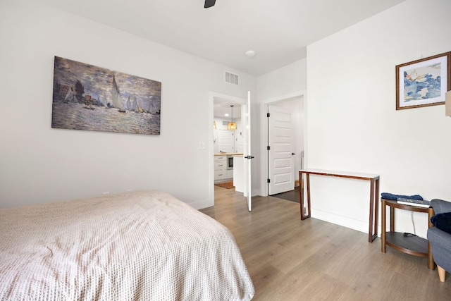 3101 Govalle Ave Unit 219, Austin, TX 78702 - bedroom featuring light wood-style floors, baseboards, and ceiling fan