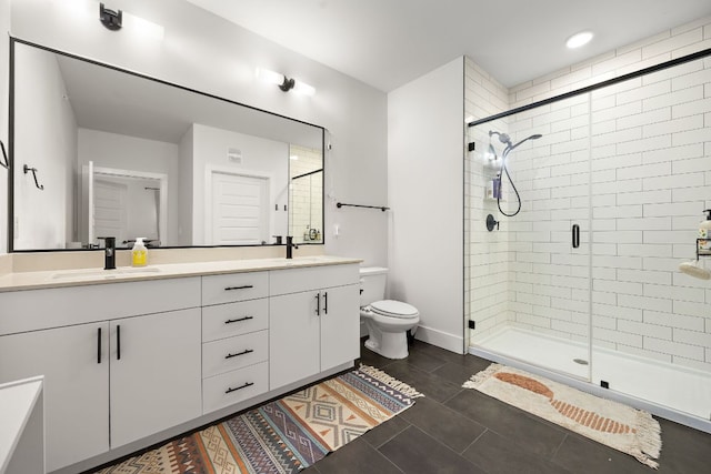 3101 Govalle Ave Unit 219, Austin, TX 78702 - bathroom featuring double vanity, a stall shower, tile patterned flooring, toilet, and baseboards