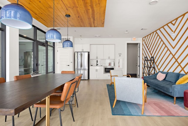 3101 Govalle Ave Unit 219, Austin, TX 78702 - dining space featuring light wood-style flooring and wooden ceiling
