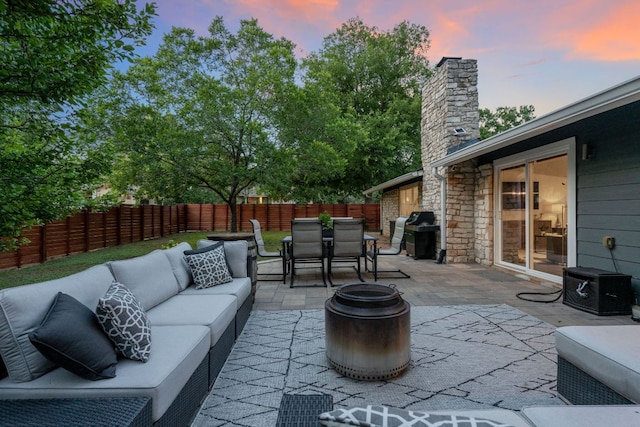 6610 Greensboro Dr, Austin, TX 78723 - patio terrace at dusk with outdoor lounge area, grilling area, outdoor dining area, a patio, and a fenced backyard