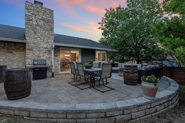 6610 Greensboro Dr, Austin, TX 78723 - patio terrace at dusk with grilling area, an outdoor living space, a patio area, and outdoor dining area