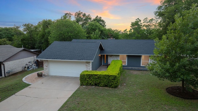 6610 Greensboro Dr, Austin, TX 78723 - view of front facade with stone siding, an attached garage, driveway, and a front lawn