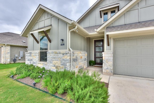 311 Westfield St, Hutto, TX 78634 - property entrance with board and batten siding, stone siding, and roof with shingles
