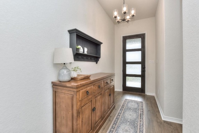 311 Westfield St, Hutto, TX 78634 - foyer entrance with a chandelier, wood finished floors, and a textured wall
