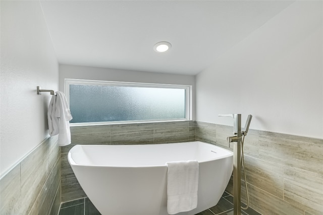 1904 Sl Davis Ave Unit 1, Austin, TX 78702 - bathroom with tile walls, wainscoting, and a soaking tub