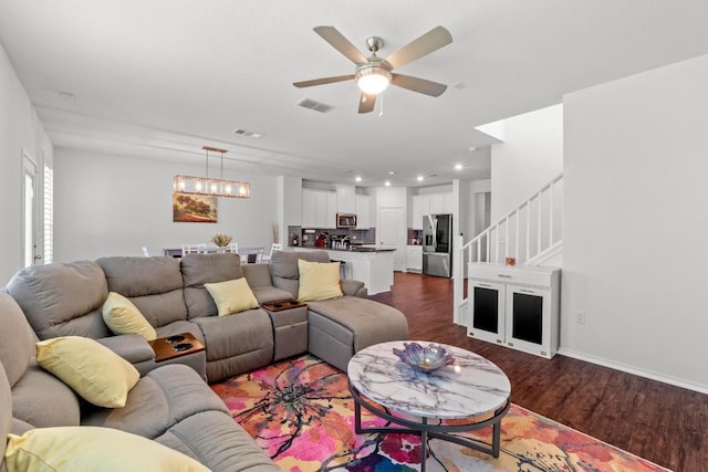 7212 Summer Tanager Dr Unit 28, Austin, TX 78744 - living room featuring dark wood-style flooring, stairs, ceiling fan, a chandelier, and recessed lighting