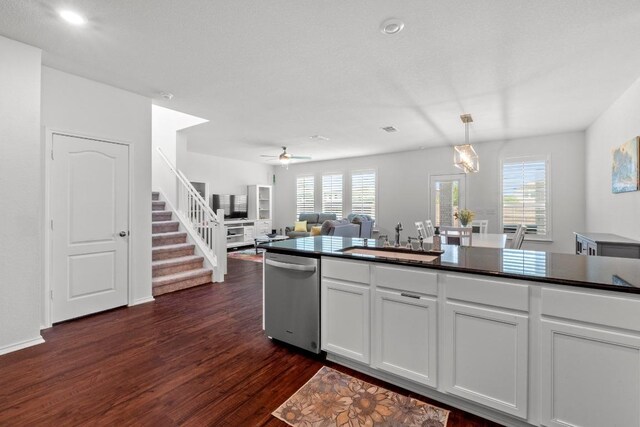 7212 Summer Tanager Dr Unit 28, Austin, TX 78744 - kitchen with dishwasher, dark wood-type flooring, dark countertops, white cabinetry, and healthy amount of natural light