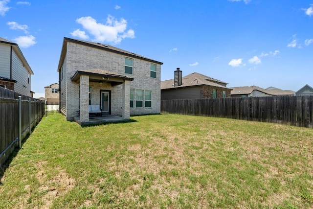 7212 Summer Tanager Dr Unit 28, Austin, TX 78744 - back of house with a fenced backyard, brick siding, and a patio