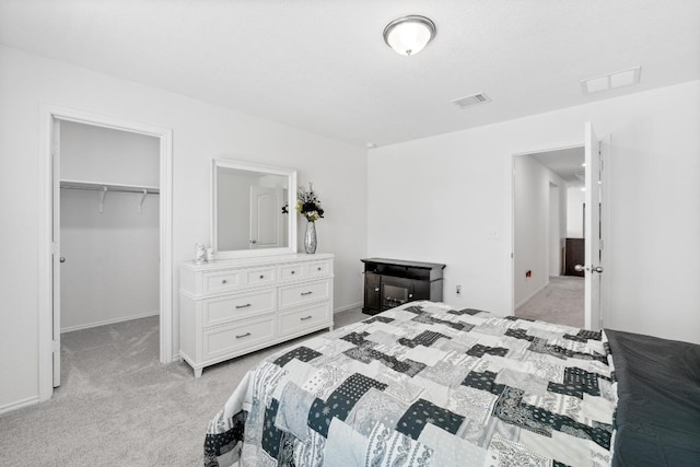 7212 Summer Tanager Dr Unit 28, Austin, TX 78744 - bedroom featuring light colored carpet, a walk in closet, and a closet