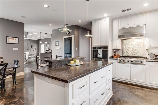 14722 Beal Dr, Corpus Christi, TX 78410 - kitchen with stainless steel appliances, under cabinet range hood, concrete flooring, recessed lighting, and a kitchen island