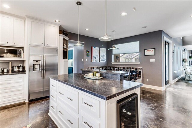 14722 Beal Dr, Corpus Christi, TX 78410 - kitchen with appliances with stainless steel finishes, wine cooler, concrete flooring, baseboards, and recessed lighting