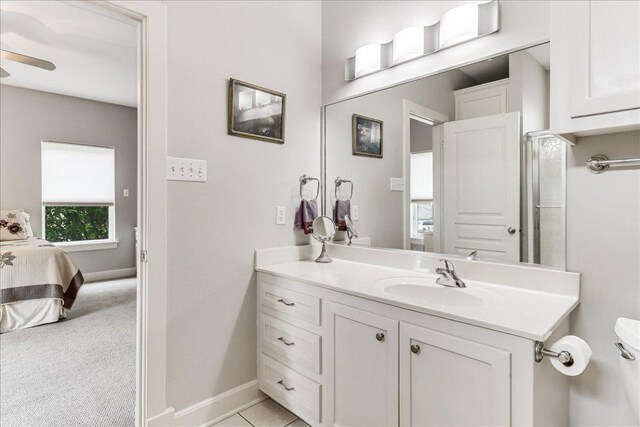 14722 Beal Dr, Corpus Christi, TX 78410 - bathroom featuring vanity, toilet, baseboards, ensuite bathroom, and a ceiling fan