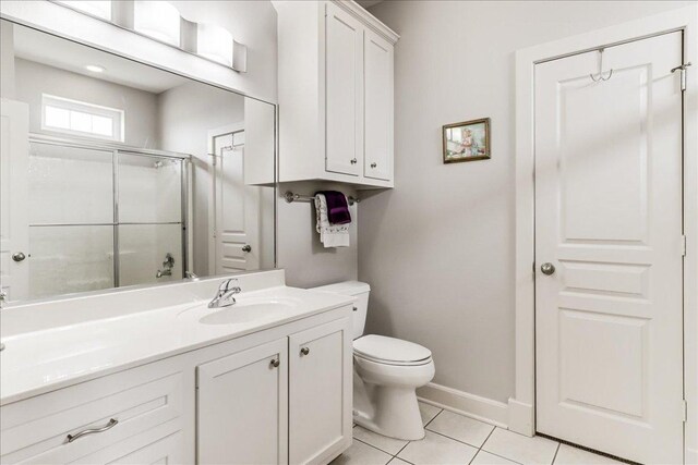 14722 Beal Dr, Corpus Christi, TX 78410 - bathroom with toilet, a shower with door, vanity, tile patterned floors, and baseboards