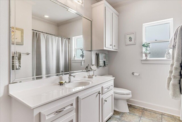 14722 Beal Dr, Corpus Christi, TX 78410 - full bath with ornamental molding, vanity, toilet, baseboards, and tile patterned flooring