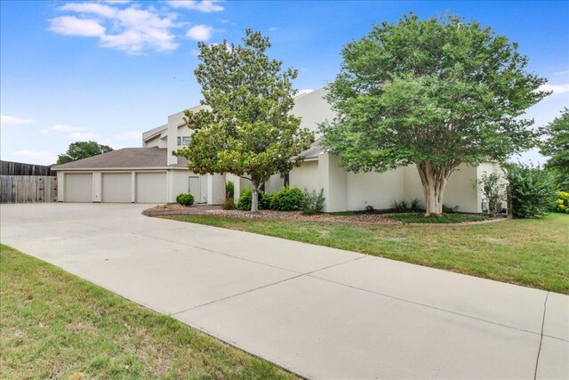 14722 Beal Dr, Corpus Christi, TX 78410 - view of front of home featuring concrete driveway, stucco siding, a front lawn, and an attached garage