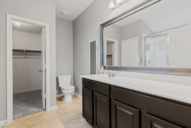 1105 Hawkeye Point Rd, Georgetown, TX 78626 - bathroom featuring a walk in closet, a stall shower, vanity, and toilet