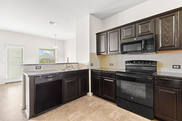 1105 Hawkeye Point Rd, Georgetown, TX 78626 - kitchen with black appliances, a sink, a peninsula, and backsplash