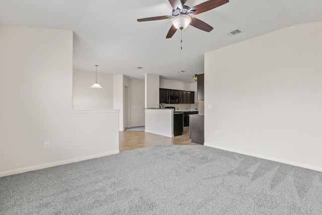 1105 Hawkeye Point Rd, Georgetown, TX 78626 - unfurnished living room with light colored carpet, a ceiling fan, and baseboards