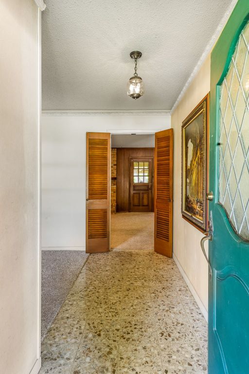 3503 Carla Dr, Austin, TX 78754 - corridor with tile patterned floors and a textured ceiling