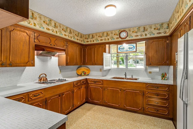 3503 Carla Dr, Austin, TX 78754 - kitchen featuring white appliances, a textured ceiling, wallpapered walls, under cabinet range hood, and light countertops