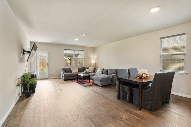 408 Rainmaker Ln, Bastrop, TX 78602 - living area with wood finished floors, baseboards, and recessed lighting