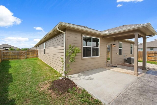 408 Rainmaker Ln, Bastrop, TX 78602 - rear view of house with a patio area and central AC unit