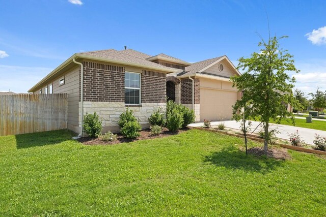 408 Rainmaker Ln, Bastrop, TX 78602 - ranch-style home featuring a garage, driveway, brick siding, stone siding, and roof with shingles