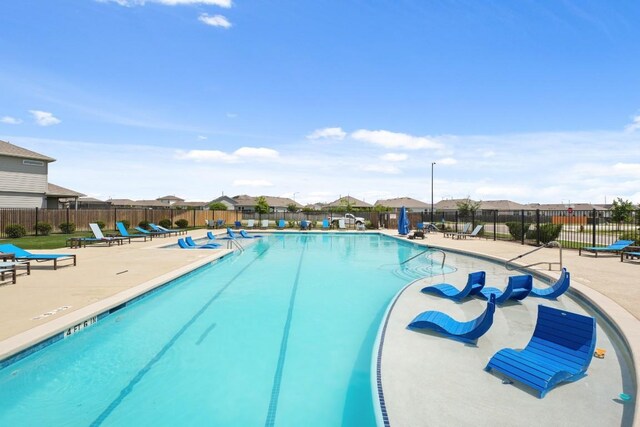 408 Rainmaker Ln, Bastrop, TX 78602 - community pool with a patio area and a residential view