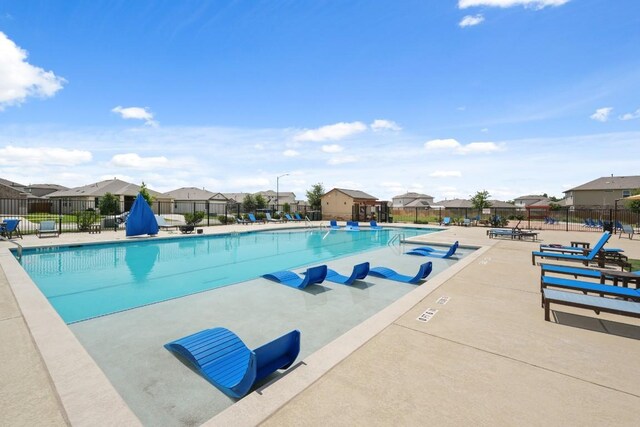 408 Rainmaker Ln, Bastrop, TX 78602 - community pool with a residential view and a patio
