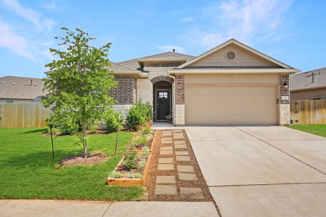 408 Rainmaker Ln, Bastrop, TX 78602 - view of front of property featuring concrete driveway, an attached garage, brick siding, stone siding, and roof with shingles