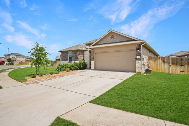 408 Rainmaker Ln, Bastrop, TX 78602 - view of front of home with a garage, concrete driveway, and stone siding