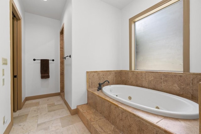 8212 Denali Pkwy, Austin, TX 78726 - bathroom featuring a jetted tub and baseboards