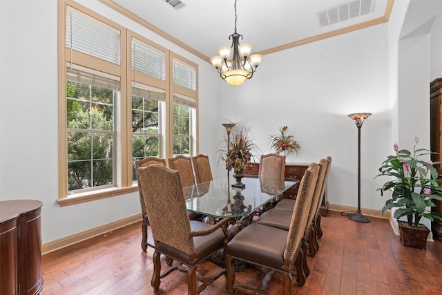 8212 Denali Pkwy, Austin, TX 78726 - dining space with crown molding, a chandelier, and hardwood / wood-style floors