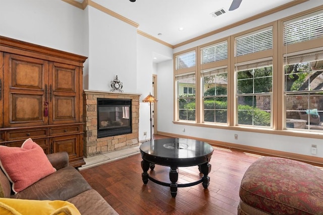 8212 Denali Pkwy, Austin, TX 78726 - living room with ornamental molding, plenty of natural light, hardwood / wood-style floors, and a stone fireplace