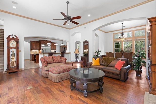 8212 Denali Pkwy, Austin, TX 78726 - living room with arched walkways, a chandelier, hardwood / wood-style flooring, ornamental molding, and ceiling fan