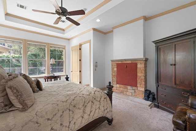 8212 Denali Pkwy, Austin, TX 78726 - bedroom featuring crown molding, a raised ceiling, carpet flooring, a brick fireplace, and a ceiling fan